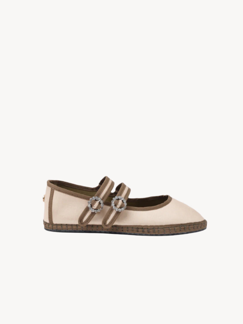 Beige flat shoe with brown accents and decorative elements on a light background
