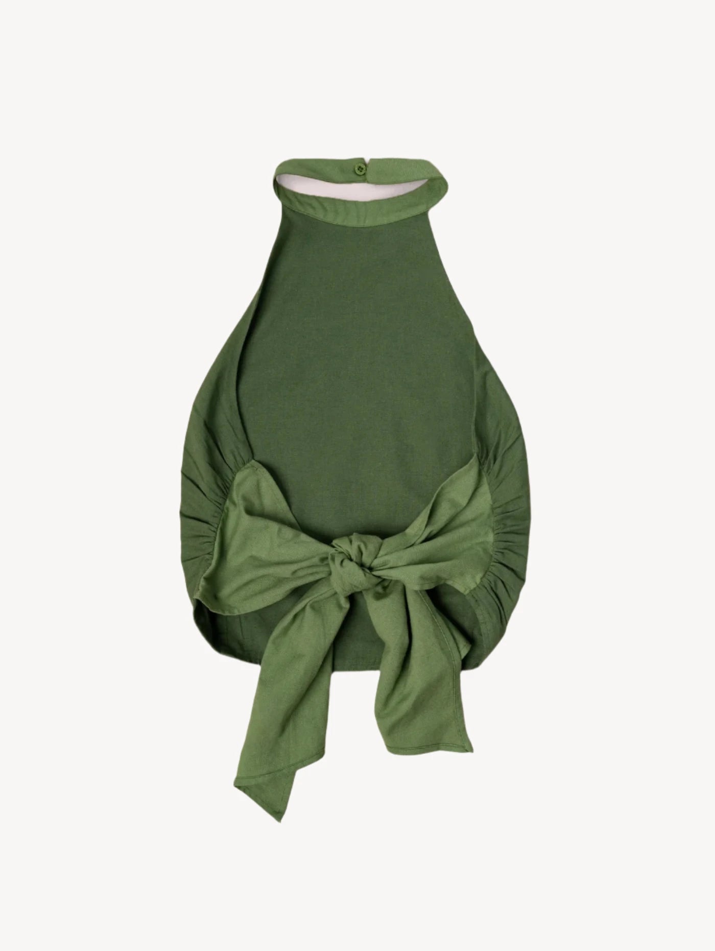 Green halter top with a bow on a light beige background