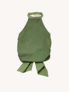 Green halter top with a knot detail on a light beige background
