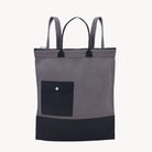 A black and charcoal gray backpack with a textured fabric, featuring a front pocket and adjustable straps.
